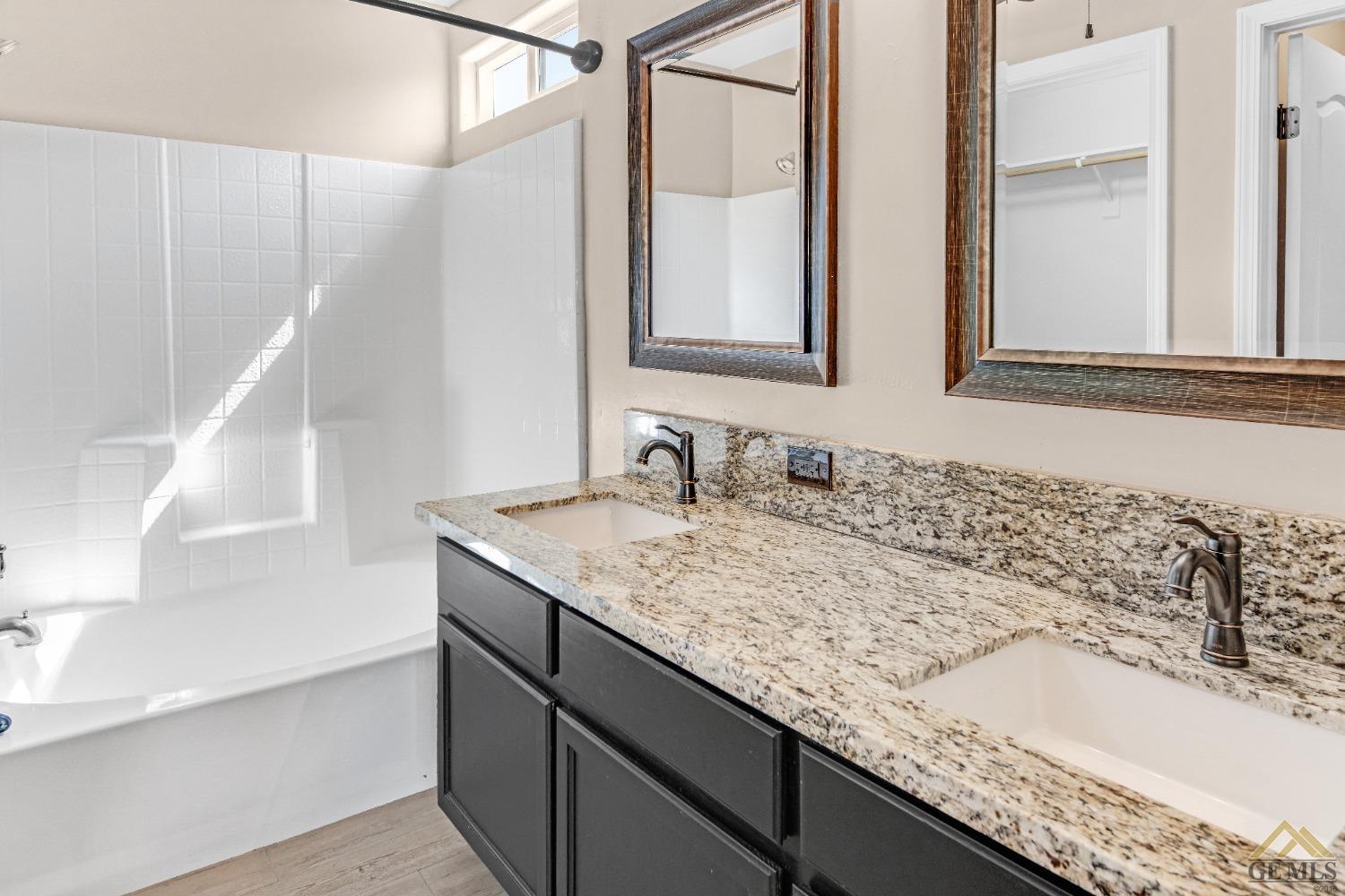 Undisclosed Address Bakersfield, CA 93312 - Photo 16 of 31 a bathroom with a granite countertop sink and a mirror