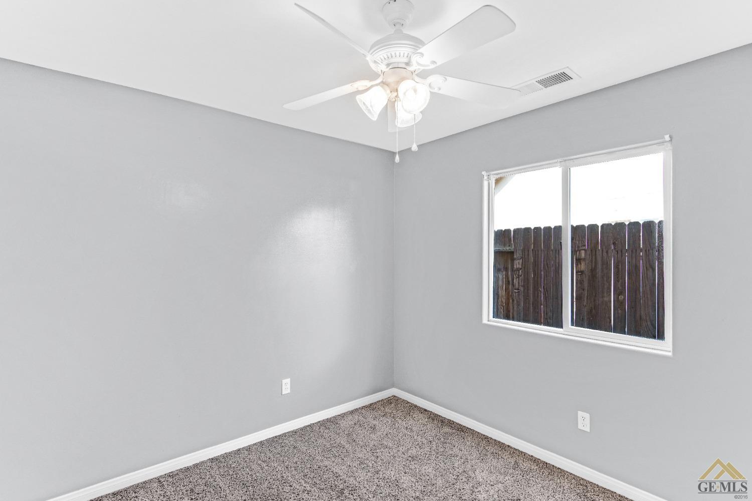 Undisclosed Address Bakersfield, CA 93312 - Photo 19 of 31 an empty room with windows and ceiling fan