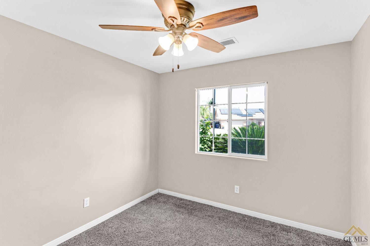 Undisclosed Address Bakersfield, CA 93312 - Photo 20 of 31 an empty room with a window and a fan