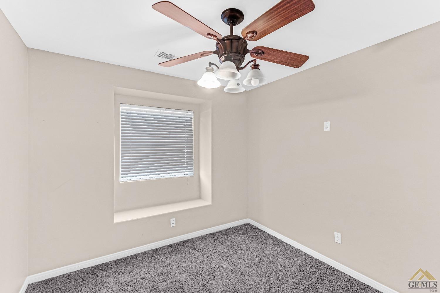 Undisclosed Address Bakersfield, CA 93312 - Photo 23 of 31 an empty room with a window and a fan