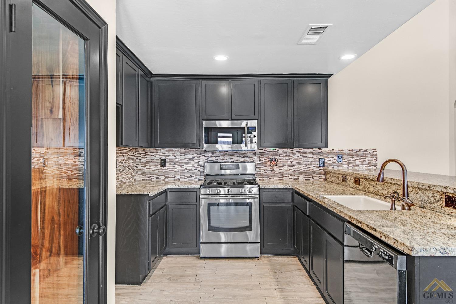 Undisclosed Address Bakersfield, CA 93312 - Photo 9 of 31 a kitchen with a sink and a refrigerator