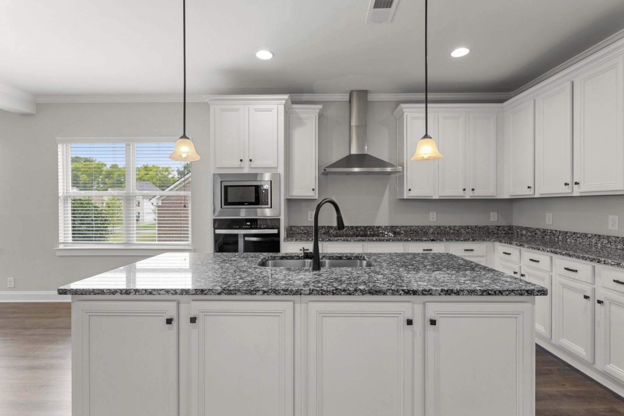 6091 Kidman Lane Spring Hill, TN 37174 - Photo 13 of 43 a kitchen with stainless steel appliances granite countertop a sink a stove and a wooden floor