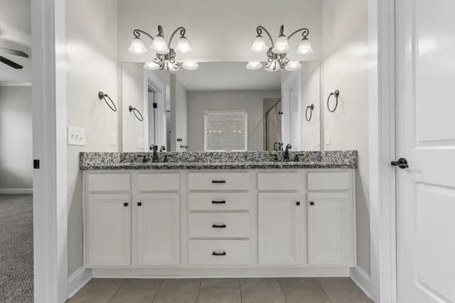 a bathroom with a double vanity sink and a mirror