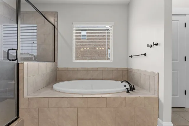 a white bath tub sitting next to a window
