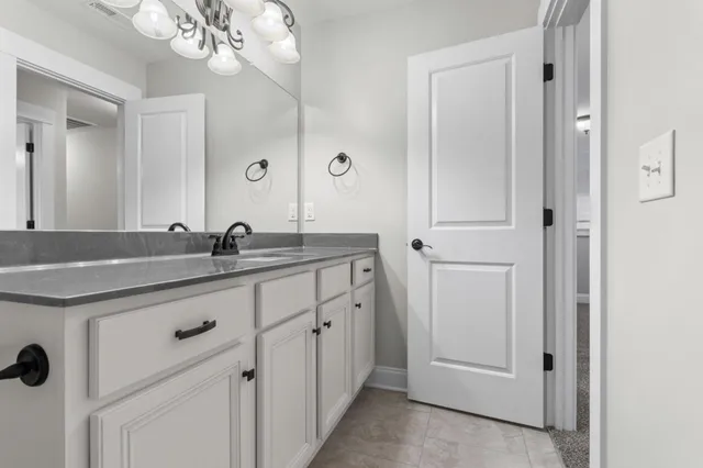 a bathroom with a double vanity sink and mirror