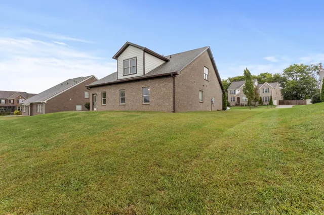 a big house with a big yard and large trees