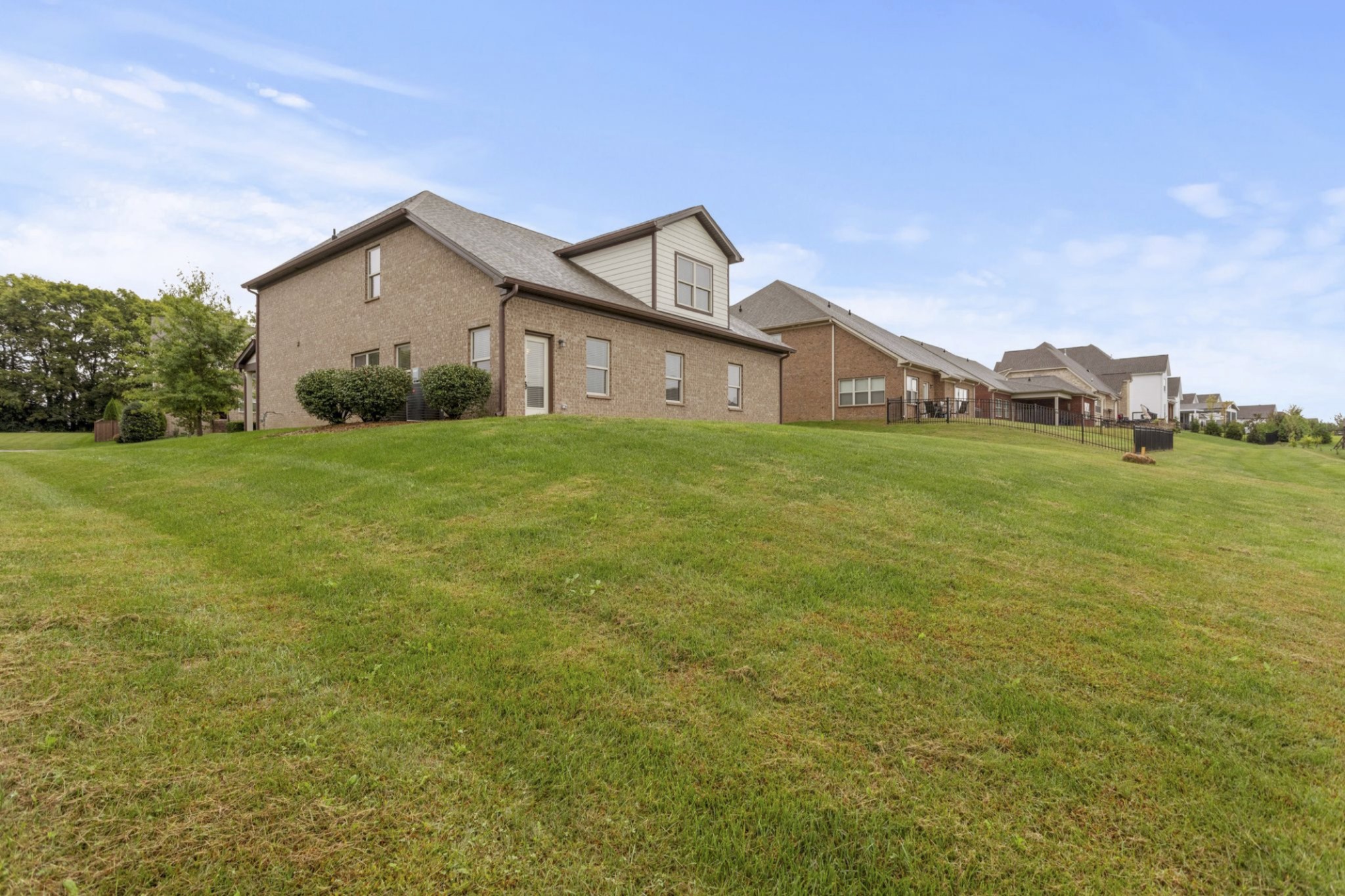 6091 Kidman Lane Spring Hill, TN 37174 - Photo 40 of 43 a view of a big house with a big yard and a large tree
