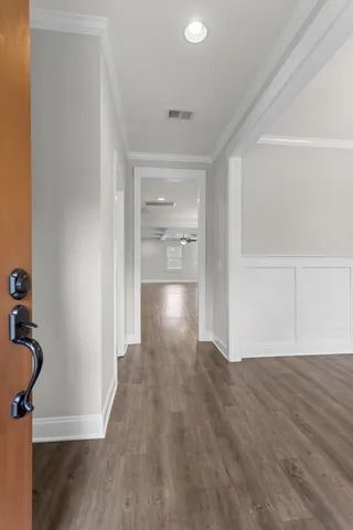 a view of empty room with wooden floor