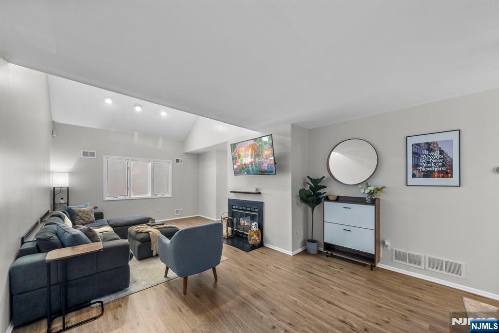 23 Bayowski Road, Unit 149 West Orange, NJ 07052 - Photo 15 of 38 a living room with furniture a window and a fireplace