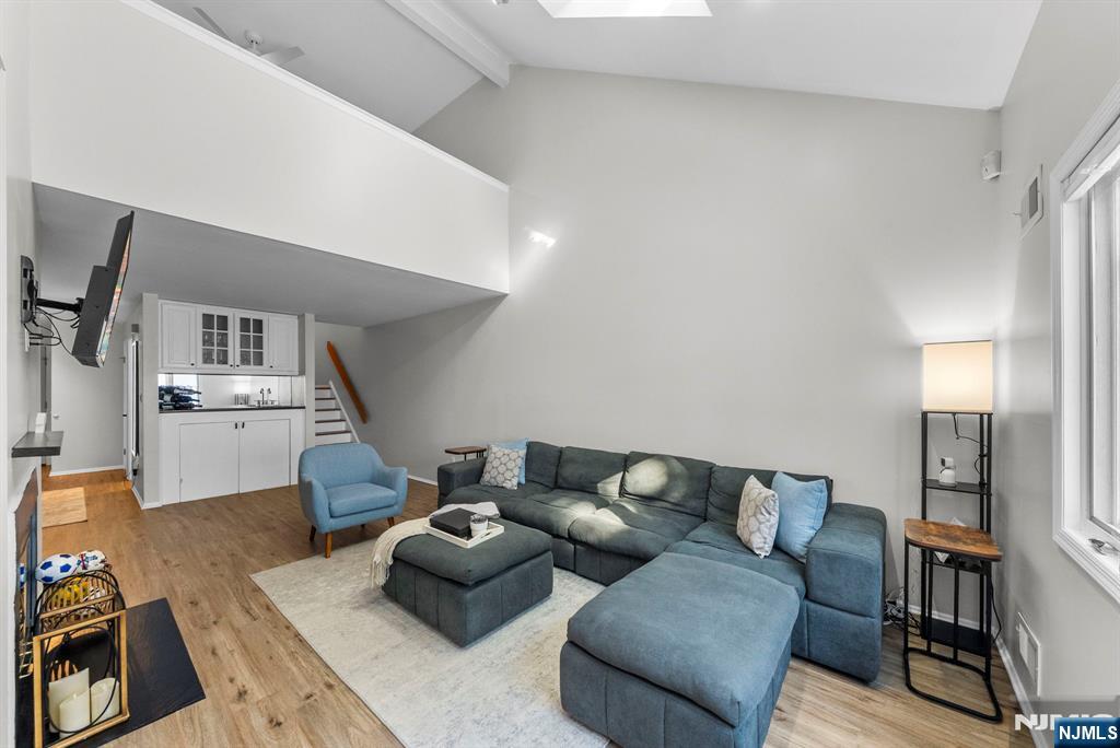 23 Bayowski Road, Unit 149 West Orange, NJ 07052 - Photo 16 of 38 a living room with furniture and view of kitchen