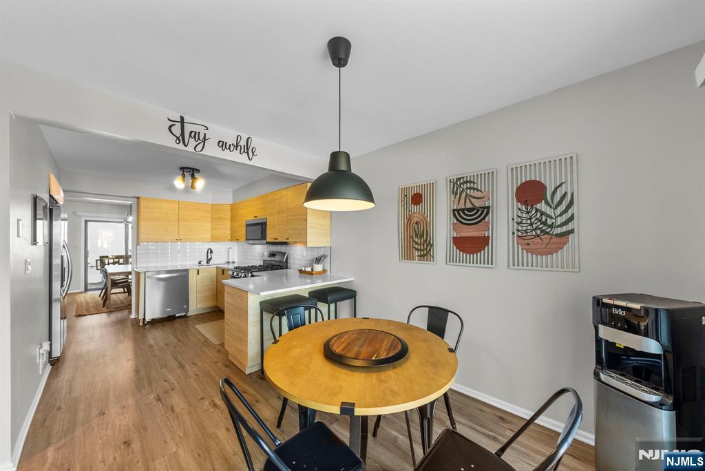 23 Bayowski Road, Unit 149 West Orange, NJ 07052 - Photo 3 of 38 a dining room with furniture and wooden floor