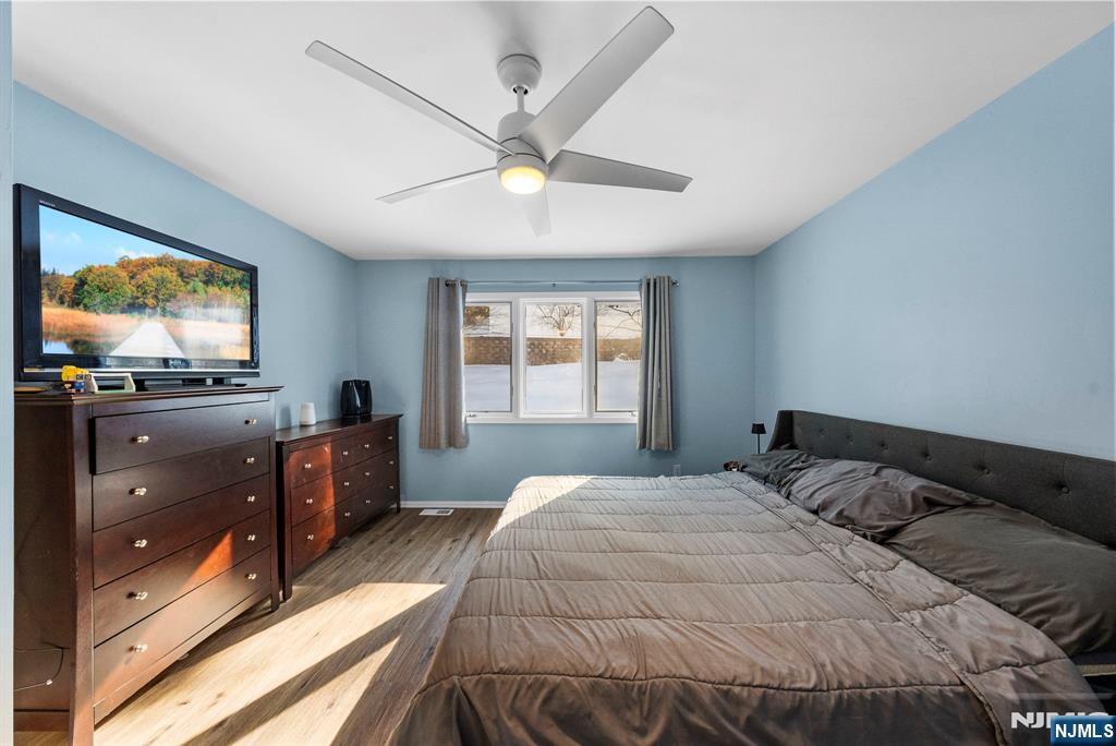 23 Bayowski Road, Unit 149 West Orange, NJ 07052 - Photo 32 of 38 a bedroom with a bed and a flat screen tv