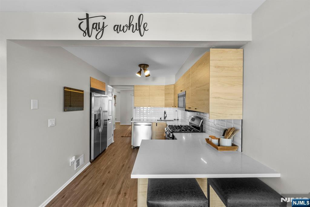 23 Bayowski Road, Unit 149 West Orange, NJ 07052 - Photo 5 of 38 a view of a dining room with furniture window and wooden floor
