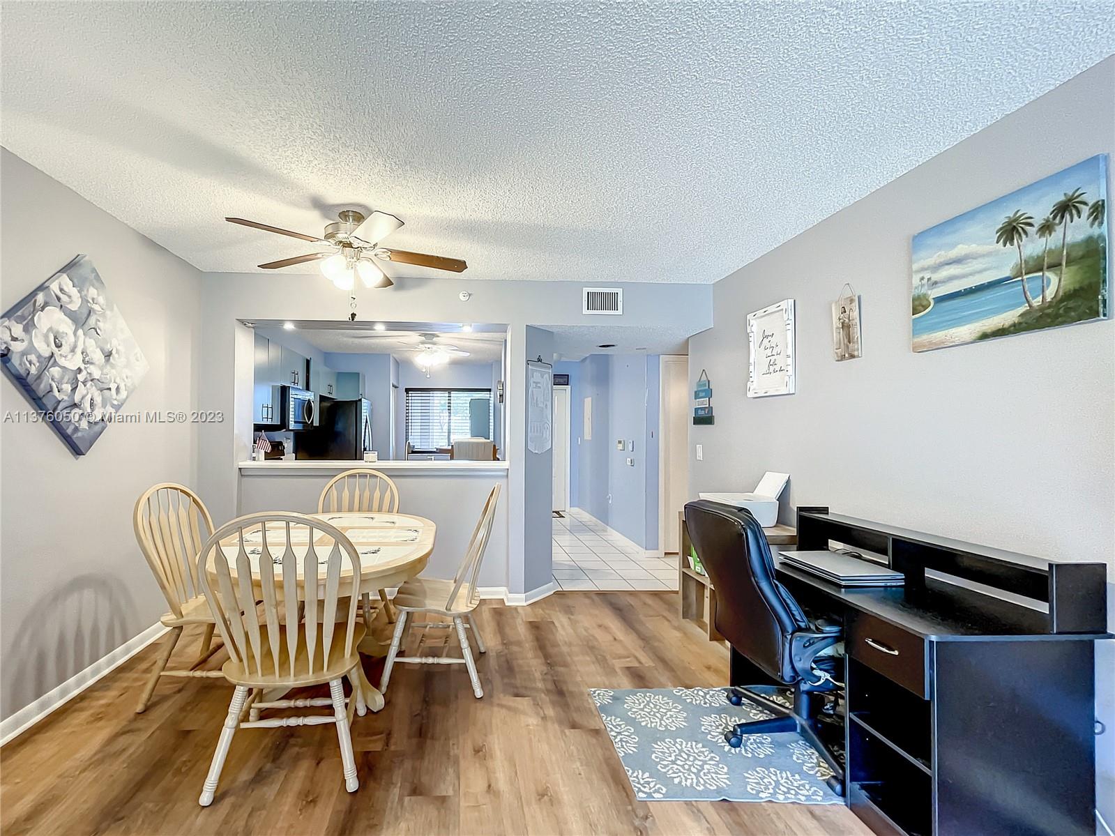 9580 Weldon Circle, Unit K110 Tamarac, FL 33321 - Photo 14 of 37 a view of a dining room with furniture and wooden floor