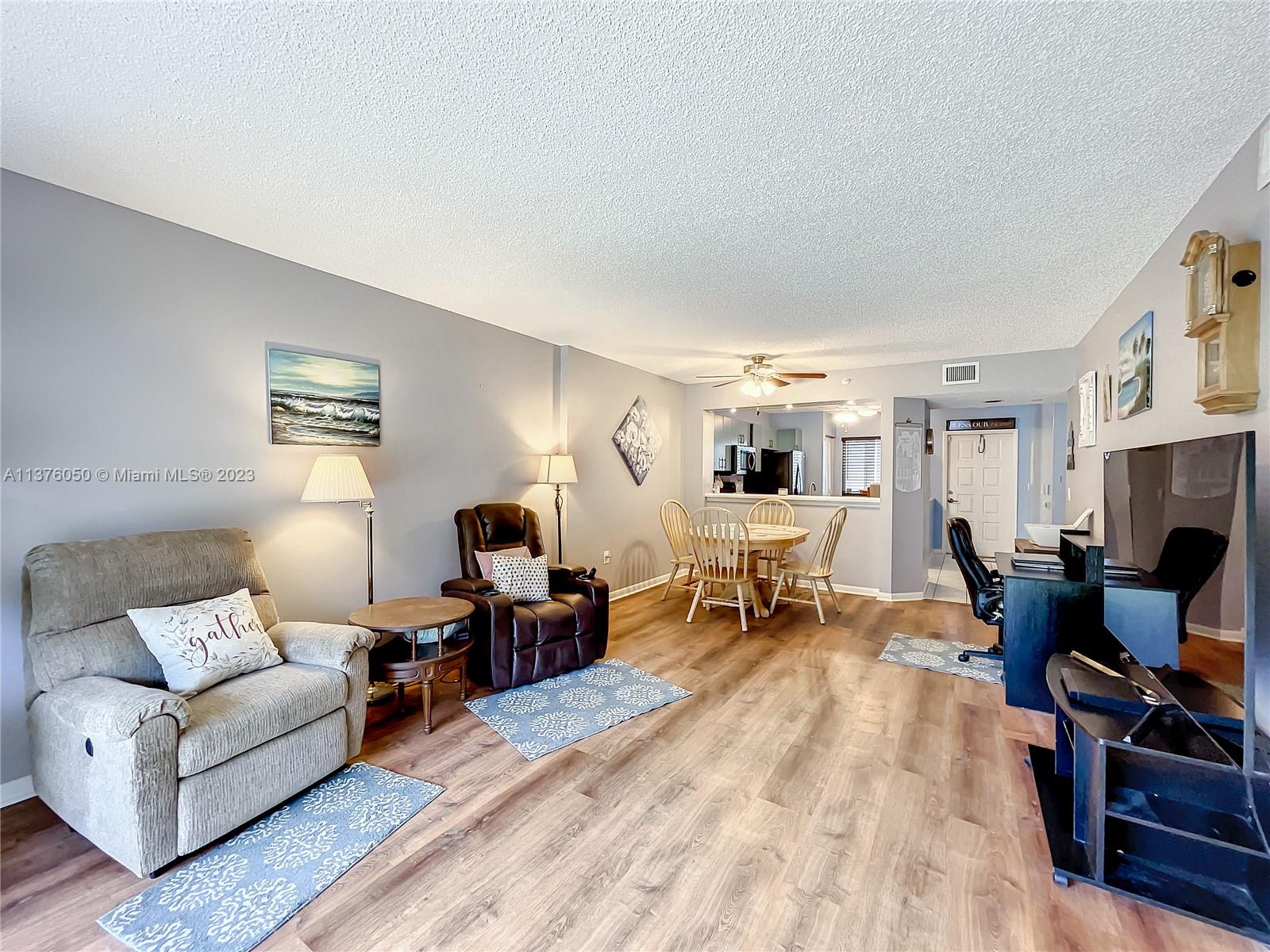 9580 Weldon Circle, Unit K110 Tamarac, FL 33321 - Photo 19 of 37 a living room with furniture and a fireplace