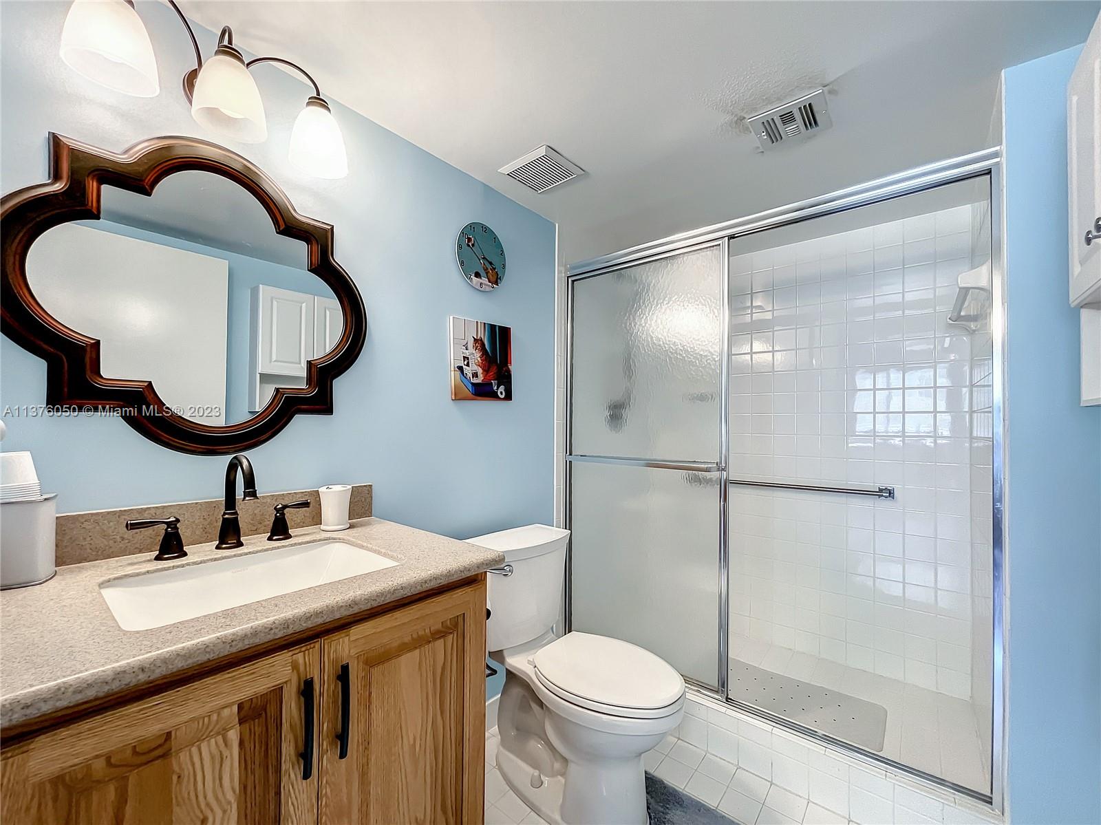 9580 Weldon Circle, Unit K110 Tamarac, FL 33321 - Photo 23 of 37 a bathroom with a sink and a mirror