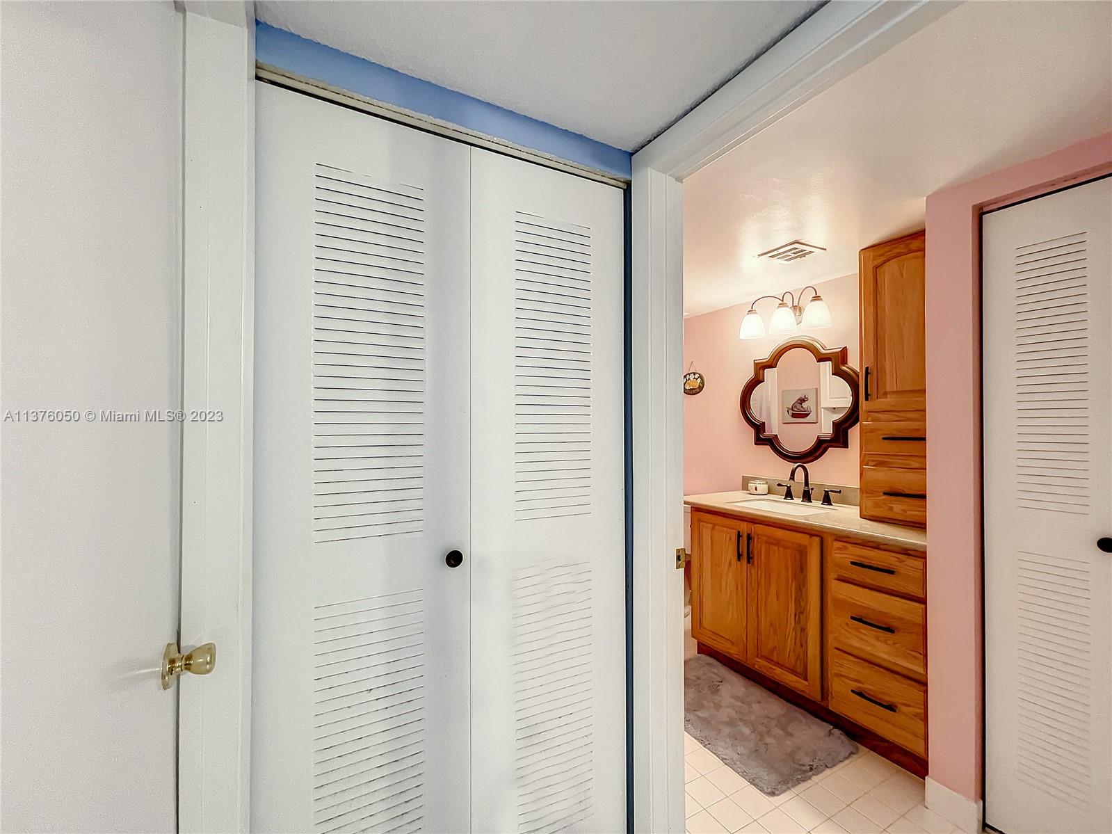 9580 Weldon Circle, Unit K110 Tamarac, FL 33321 - Photo 27 of 37 a bathroom with a mirror and a shower