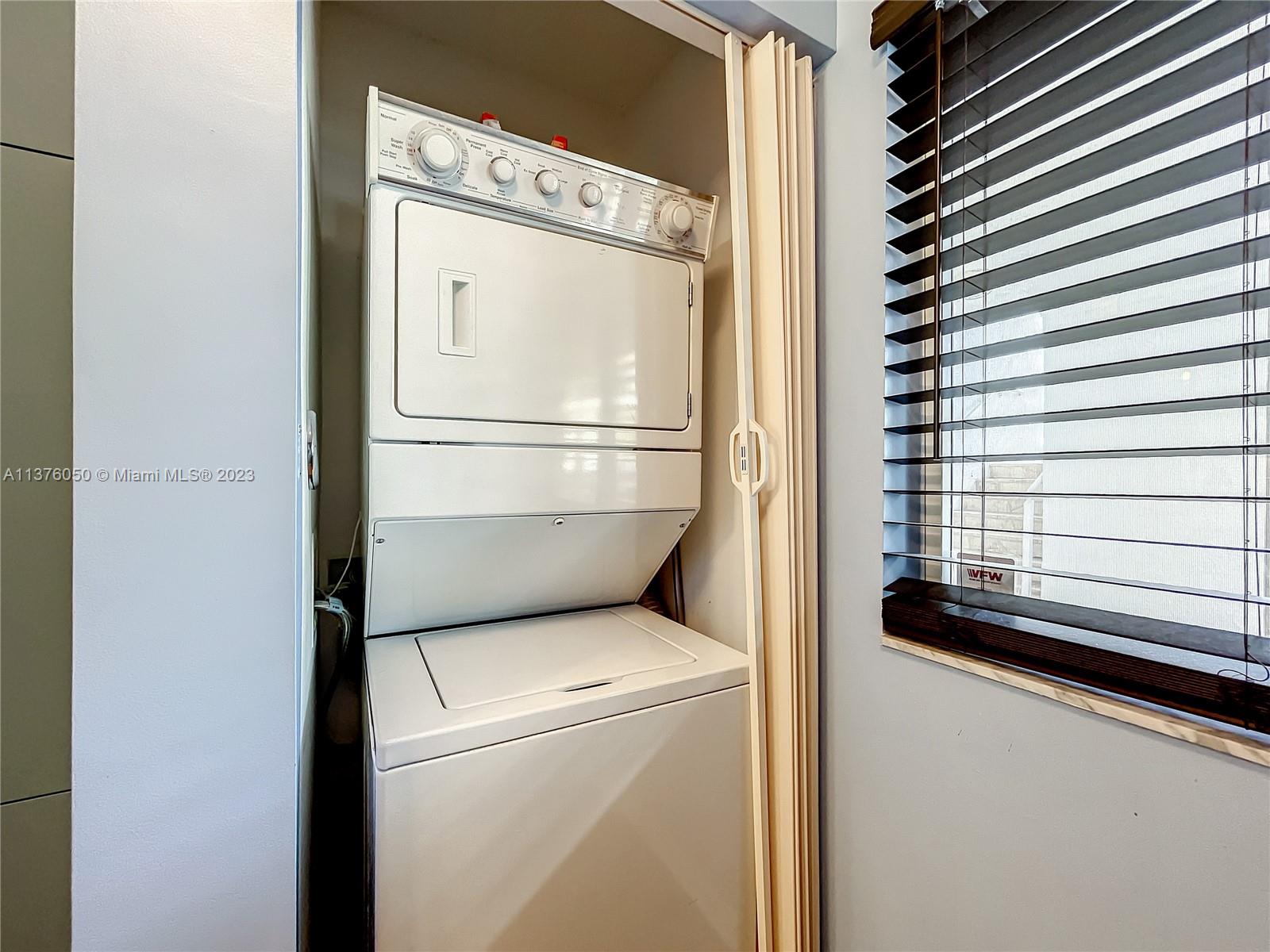 9580 Weldon Circle, Unit K110 Tamarac, FL 33321 - Photo 29 of 37 a utility room with dryer and washer