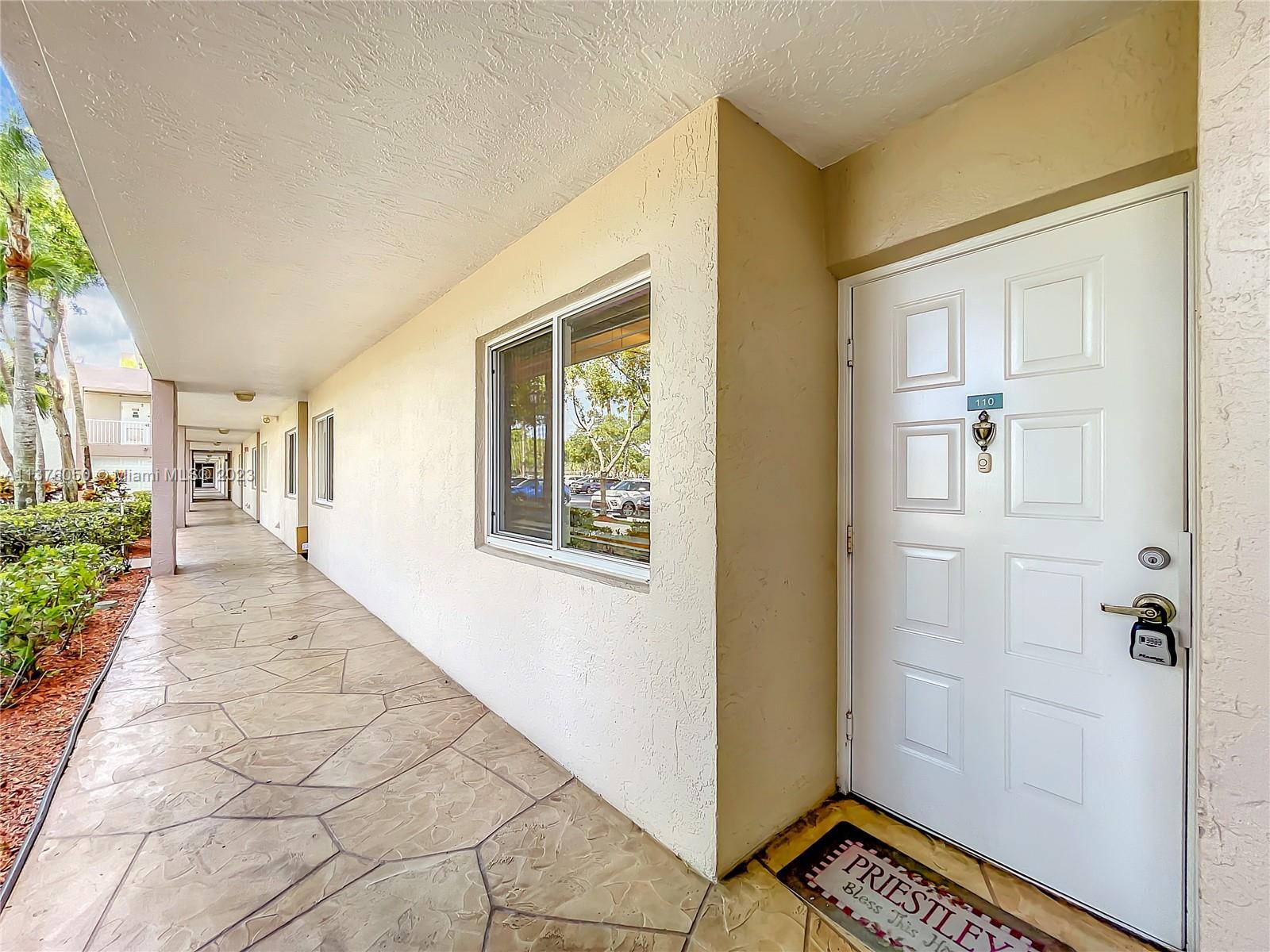 9580 Weldon Circle, Unit K110 Tamarac, FL 33321 - Photo 5 of 37 view of an entryway with wooden floor and windows
