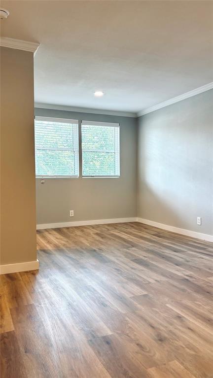 4603 Junius Street, Unit 9 Dallas, TX 75246 - Photo 1 of 9 an empty room with wooden floor and windows
