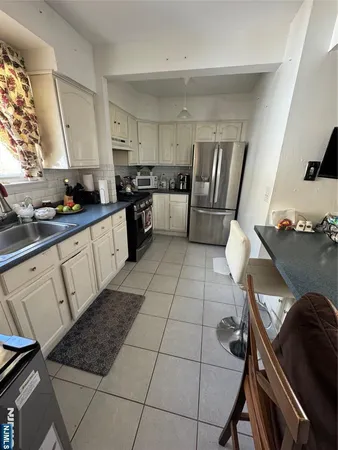 a kitchen with a sink a stove and refrigerator