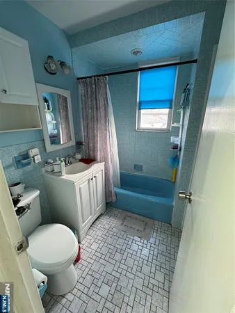 a bathroom with a sink a toilet a mirror and vanity