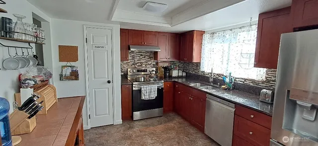a view of a dining room with furniture and chandelier