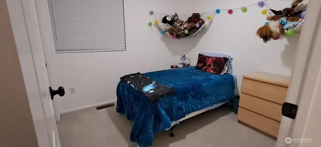 a bedroom with a bed and a flat tv screen