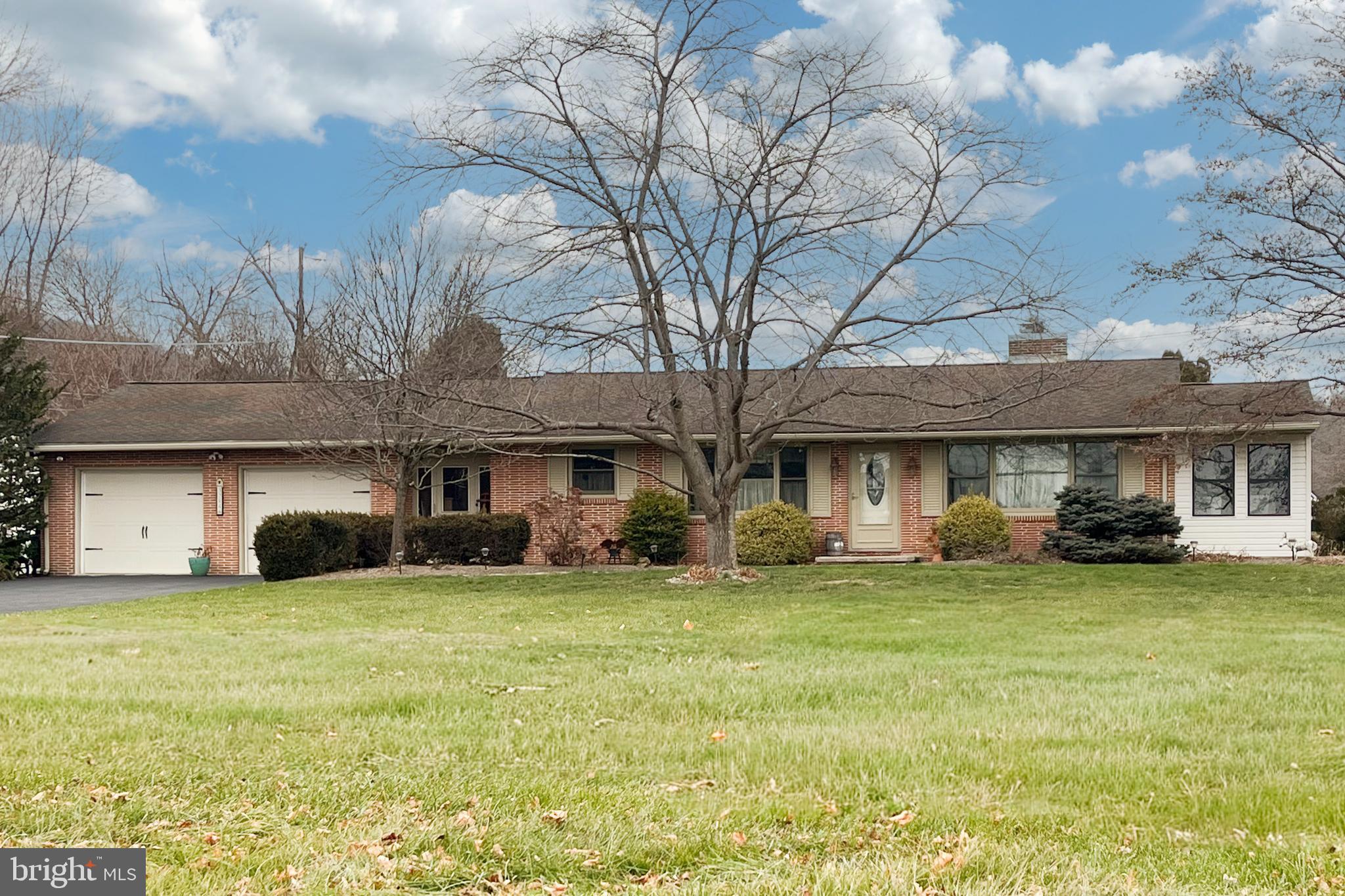 a view of a house with a yard and sitting area