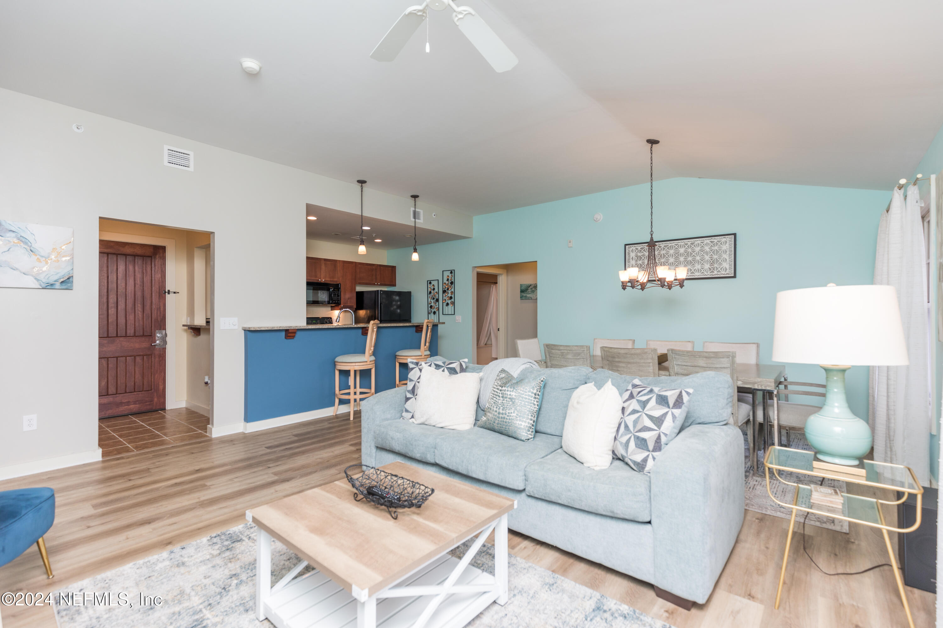 955 Registry Boulevard, Unit 308 St. Augustine, FL 32092 - Photo 20 of 55 a living room with furniture and a wooden floor