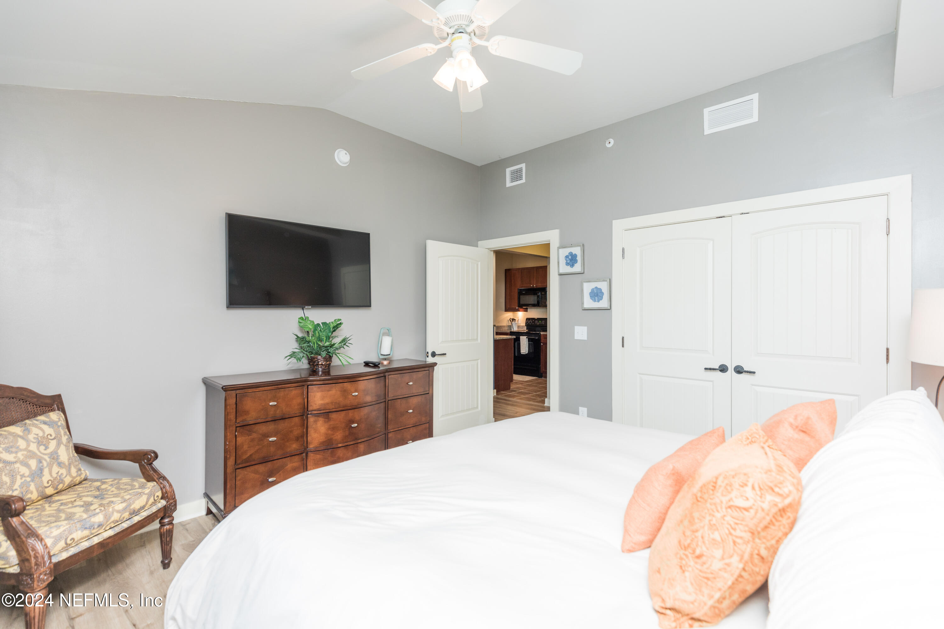 955 Registry Boulevard, Unit 308 St. Augustine, FL 32092 - Photo 23 of 55 a bedroom with a bed and a flat screen tv
