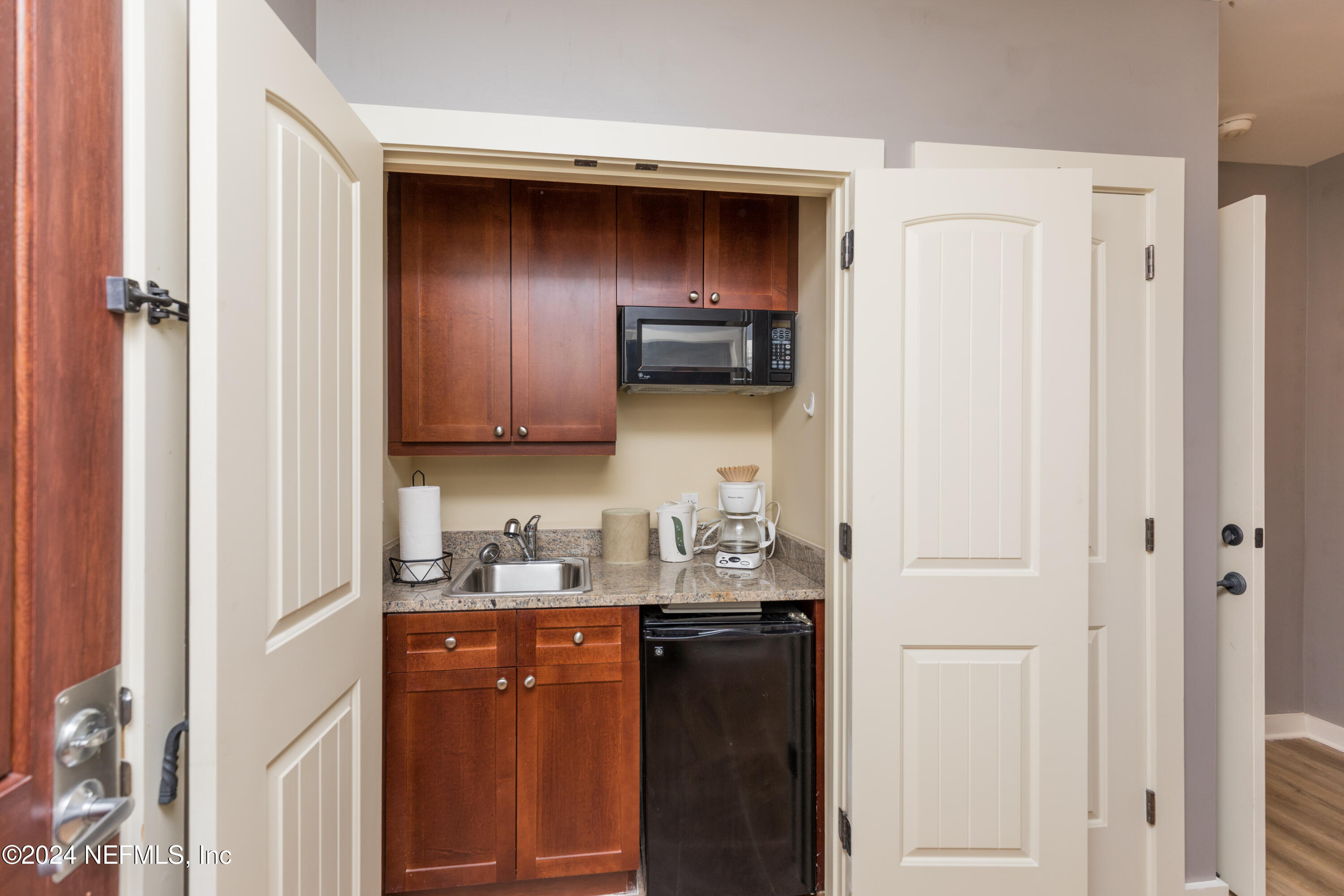955 Registry Boulevard, Unit 308 St. Augustine, FL 32092 - Photo 27 of 55 a kitchen with a refrigerator and a sink