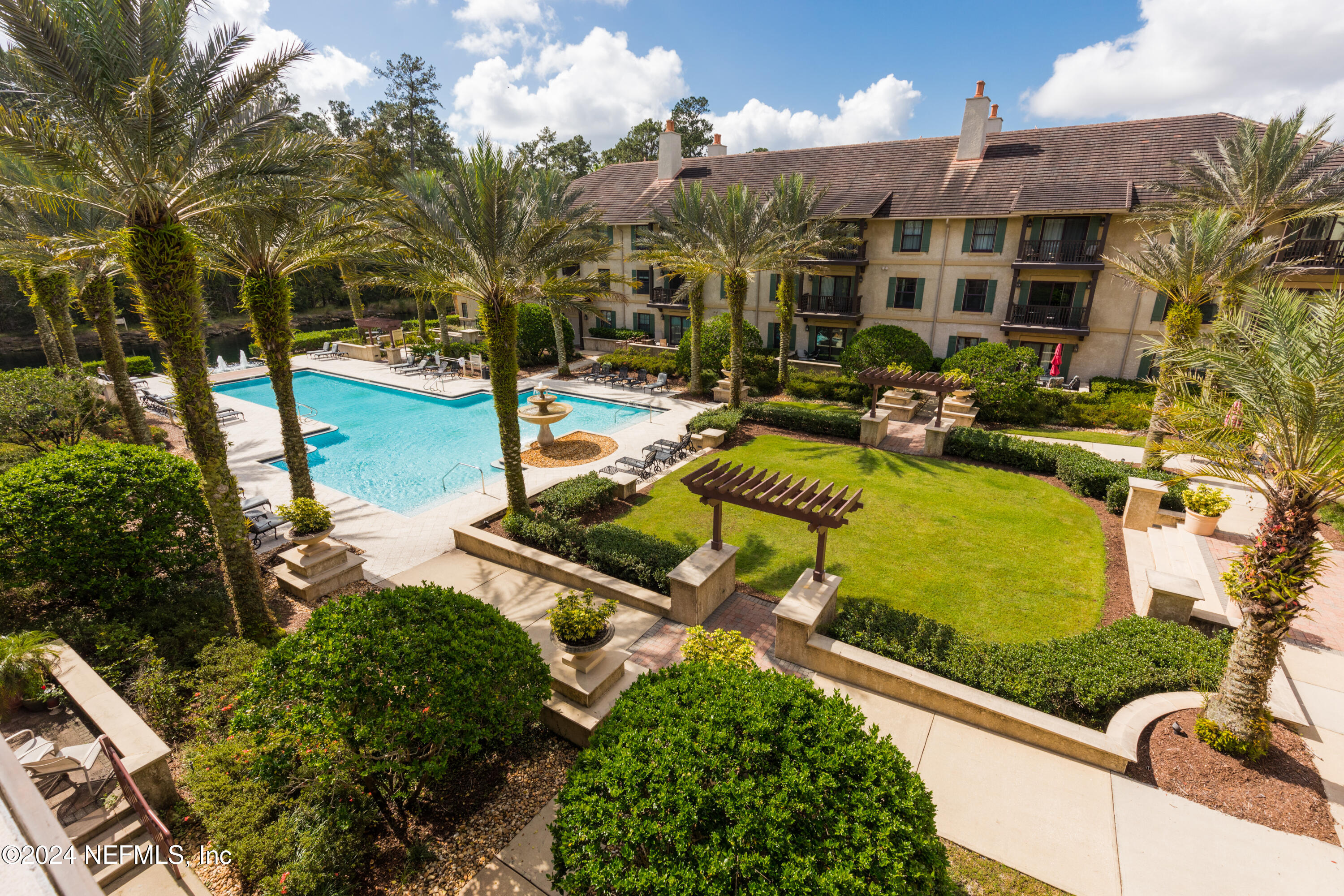 955 Registry Boulevard, Unit 308 St. Augustine, FL 32092 - Photo 37 of 55 a view of a swimming pool with a patio and a yard