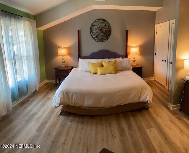 955 Registry Boulevard, Unit 308 St. Augustine, FL 32092 - Photo 6 of 55 a bedroom with a bed and wooden floor
