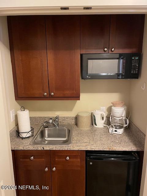 955 Registry Boulevard, Unit 308 St. Augustine, FL 32092 - Photo 9 of 55 a kitchen with granite countertop a sink dishwasher stove and cabinets