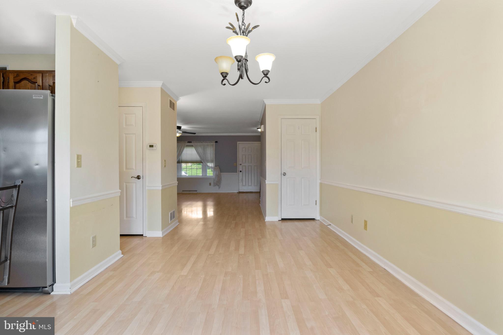 503 Chambers Ridge York, PA 17402 - Photo 14 of 34 a view of a hallway with wooden floor and a chandelier