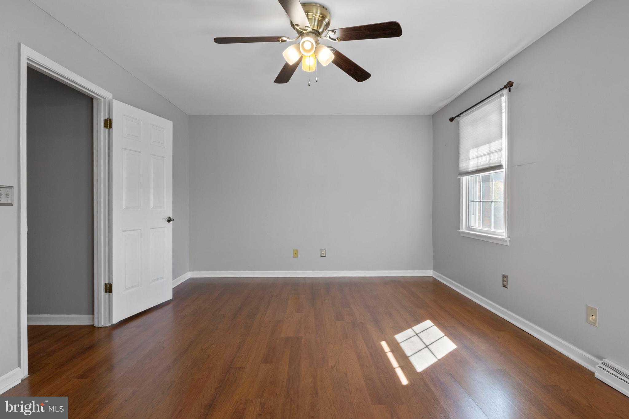 503 Chambers Ridge York, PA 17402 - Photo 19 of 34 an empty room with wooden floor chandelier fan and windows