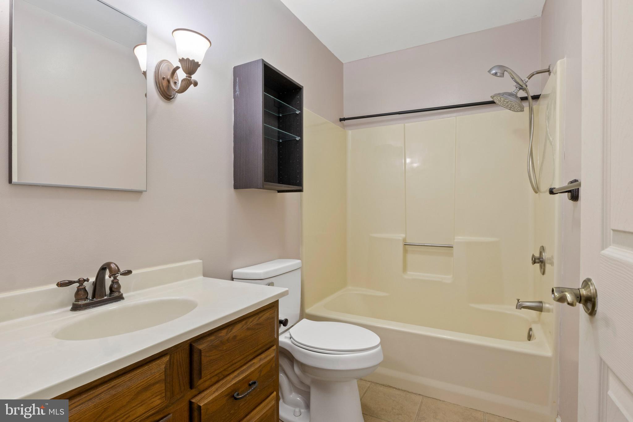 503 Chambers Ridge York, PA 17402 - Photo 23 of 34 a bathroom with a sink a toilet a mirror and shower