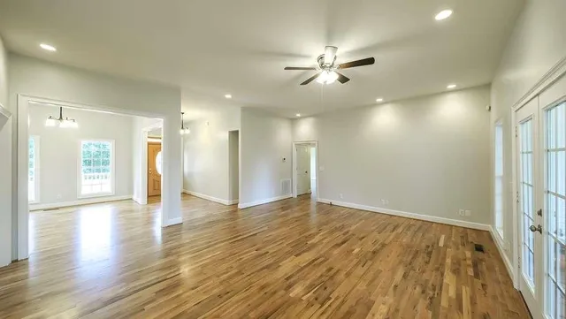 a view of an empty room and wooden floor