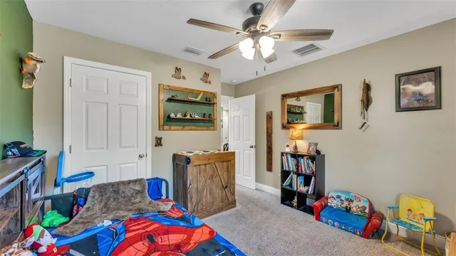 a living room with furniture and a baby crib