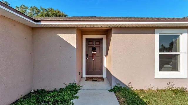 a front view of a house with a small garden