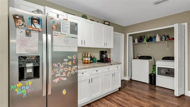 a kitchen with stainless steel appliances granite countertop a refrigerator and a stove top oven