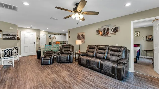 a living room with furniture and wooden floor