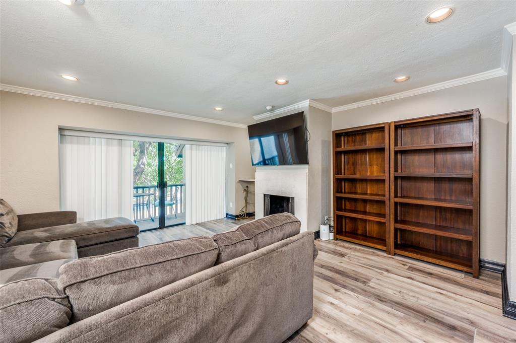 4517 North O'Connor Road, Unit 1138 Irving, TX 75062 - Photo 4 of 24 Living room with light hardwood / wood-style flooring, a textured ceiling, and ornamental molding