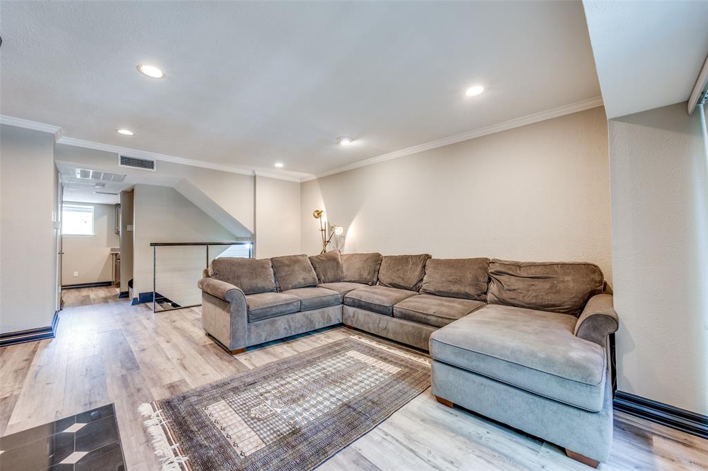 4517 North O'Connor Road, Unit 1138 Irving, TX 75062 - Photo 5 of 24 Living room with ornamental molding and light hardwood / wood-style floors