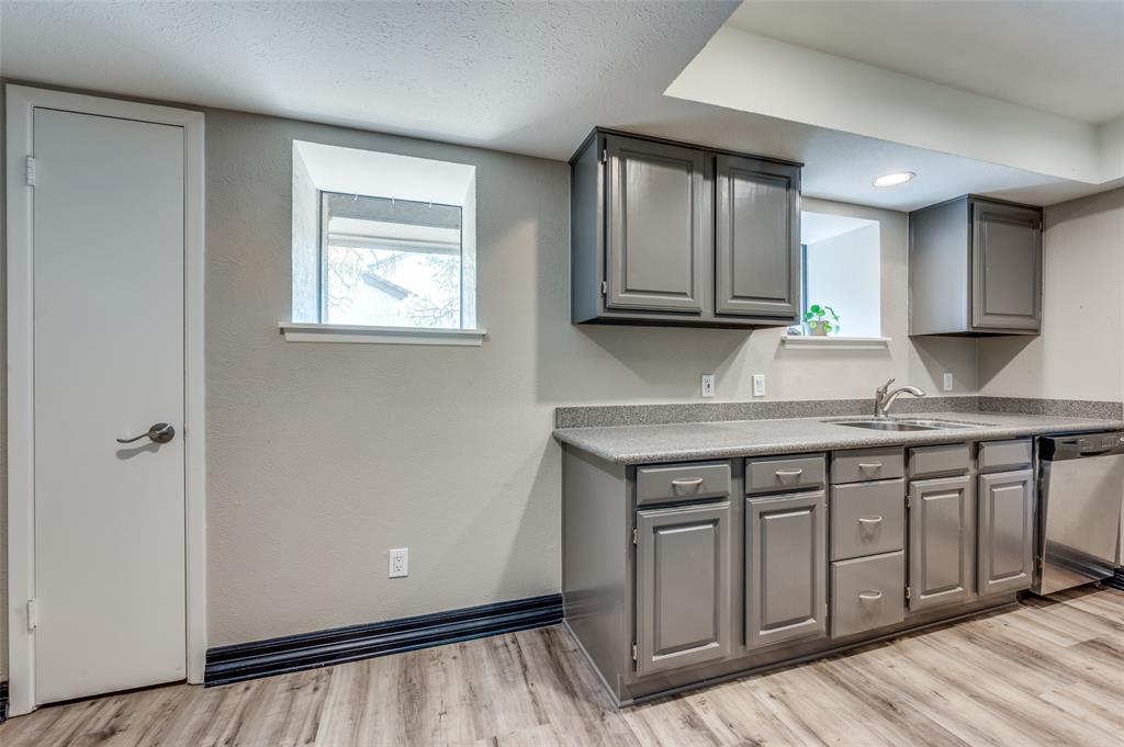 4517 North O'Connor Road, Unit 1138 Irving, TX 75062 - Photo 8 of 24 Kitchen with gray cabinetry, sink, and light hardwood / wood-style floors