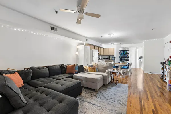 a living room with furniture and wooden floor