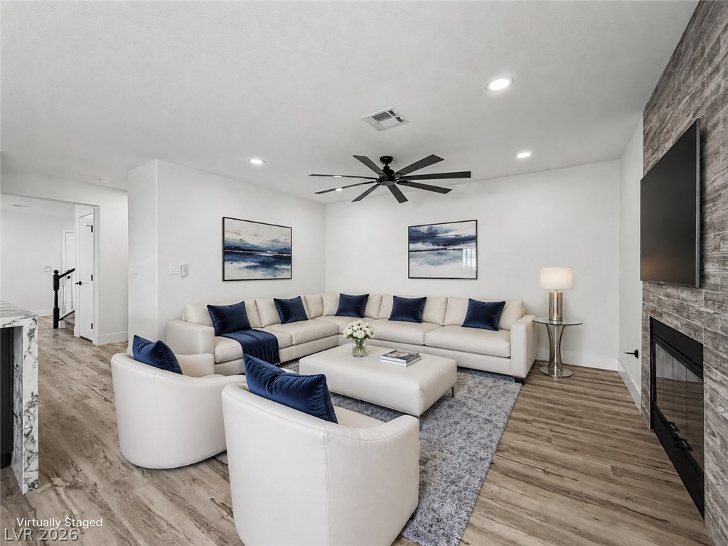 8977 Paige Rene Court Las Vegas, NV 89117 - Photo 16 of 31 An inviting living room features elegant wood flooring, recessed lighting, and a modern ceiling fan.