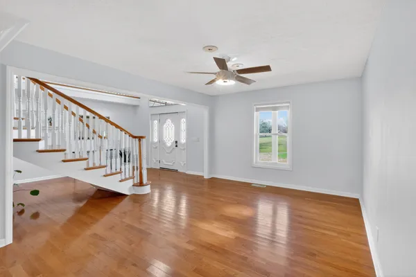 a bedroom with furniture and wooden floor