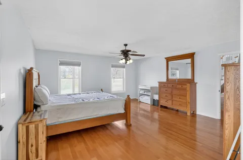 a spacious bathroom with a granite countertop shower a mirror and a sink